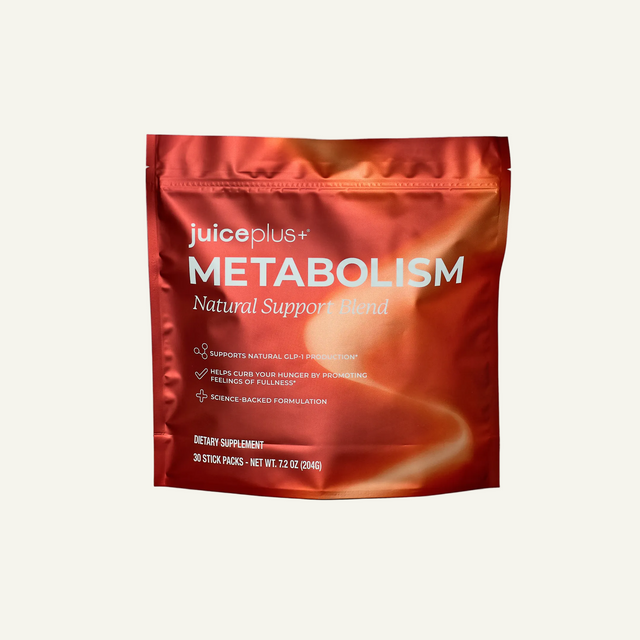 Juiceplus+ Metabolism Natural Support Blend in a metallic red stand-up pouch, displayed on a light gray background with a soft shadow.