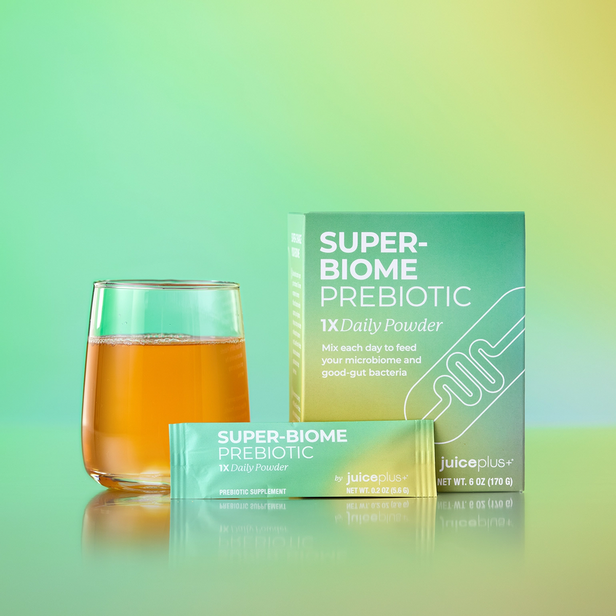 Super-Biome Prebiotic packaging with a glass of juice on a gradient green background