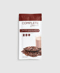 A sachet of Juice Plus+ Complete Dutch Chocolate flavor, showing the product name, an image of chocolate chips, and a prepared chocolate drink.
