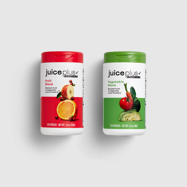 Two bottles of Juice Plus+ supplements, one labeled 'Fruit Blend' and the other 'Vegetable Blend'.